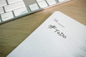 A desk planner open at a to-do page next to a keyboard
