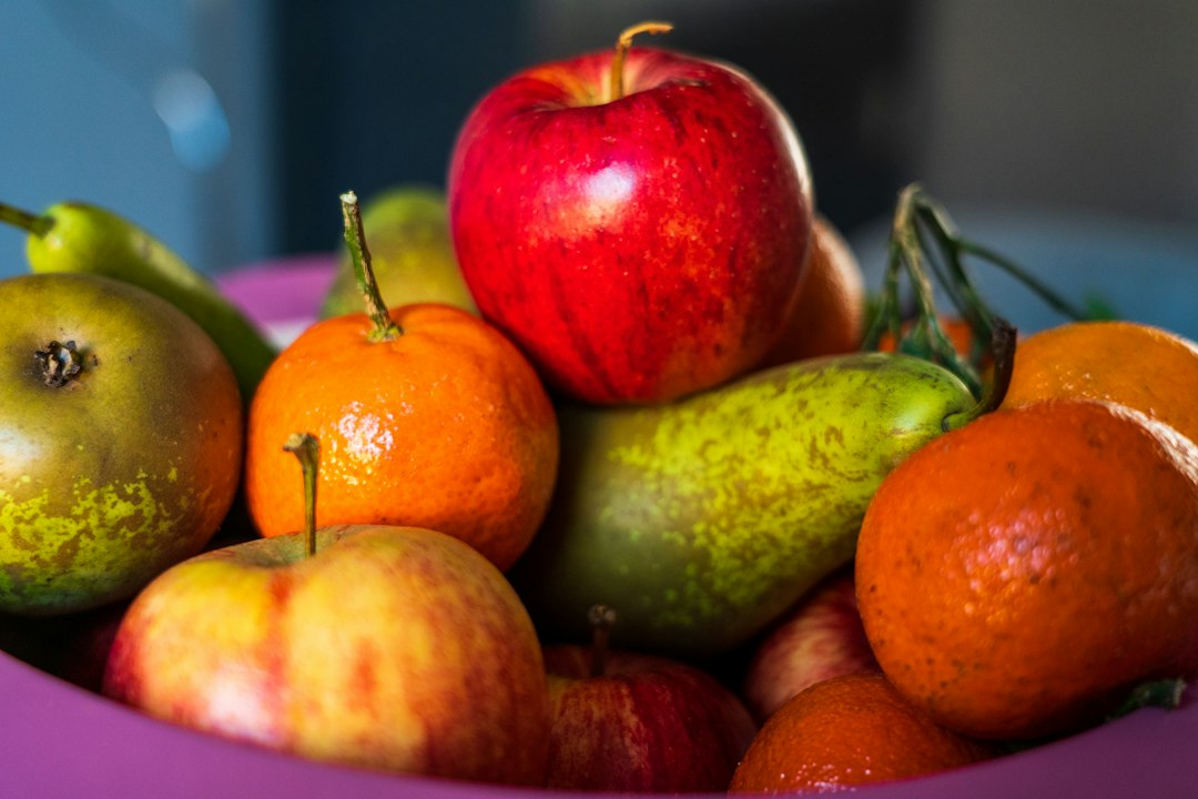 Bowl of fresh apples, pears and clementines, a naturally sweet wholesome snack
